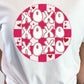 A person wearing a white t-shirt with a red and pink checkered pattern on it, and the text 'XOXO' in the center.