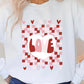 A female model wearing a white checkered pattern t-shirt with a heart and the word 'love' on the front.