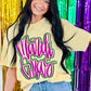 A person wearing a yellow t-shirt with neon purple and green glitter, and the text 'MARDI GRAS' in cursive script.