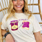 Person wearing a white t-shirt with graphics and text "Go spread it", sitting on a wicker chair.