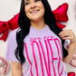 A woman smiling and wearing a purple t-shirt with the text 'you are LOVED' printed in large pink letters.