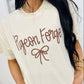 Person wearing a white t-shirt with 'Pigeon Forge' text and bow graphic.