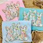 A collection of Easter-themed graphic tees with watercolor bunny designs, displayed on a neutral background.
