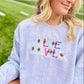 Person wearing a gray sweatshirt with 'Blue Devils' text and football icons on a sports field background
