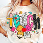 T-shirt with colorful 'TEACH' design and personalized name on a plain background