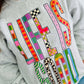 Gray sweatshirt with colorful text design worn by a person.