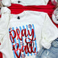 White sweatshirt with 'Play Ball' text on a red surface with denim shorts and disco balls.