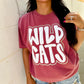 A person wearing a red t-shirt with 'WILD CATS' text in white puff vinyl and champagne glitter.