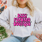 A woman wearing a gray sweatshirt with 'DASH FORWARD BOUTIQUE' text in pink on the front.