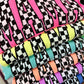 A stack of various Neon colored t-shirts with a checkered custom pattern MAMA.