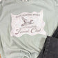Light green t-shirt with Duck Hunting Wives Social Club graphic design on a textured surface