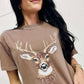 Woman wearing a Espresso t-shirt with a deer graphic design.