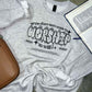 Gray sweatshirt with If the stars were made to worship so will I on a gray surface next to a brown bag and open Bible.