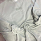 Light gray sweatshirt with 'MAMA' embroidery on a concrete floor