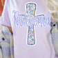 Person wearing a light purple t-shirt with a floral cross design and 'Redeemed' text.