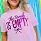 Person wearing a pink t-shirt with 'the tomb is empty' puff metallic text in front of a colorful striped background