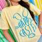 Person wearing a yellow t-shirt with 'Happy Easter' Bunny cotton tail Puff vinyl design against colorful striped background
