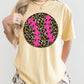 Person wearing a yellow t-shirt with a pink and black Leopard design on a white background