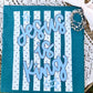 Card with 'Jesus is King' text on a blue and white striped background, placed on a textured surface.