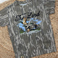 Camouflage-patterned t-shirt with duck design and text on a woven surface
