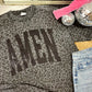 Gray leopard print sweatshirt with 'AMEN' glitter text, pink gloves, disco balls, and jeans on a surface.