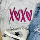 A Smoke Comfort Color t-shirt with pink 'XOXO' heart applique, paired with blue denim jeans and white sneakers with a star pattern.