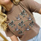 Woman wearing a Espresso t-shirt with duck bow designs on a white background