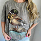 Woman wearing a gray t-shirt with a duck graphic design.