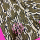 Camouflage patterned fabric with pink monogram on a pink background
