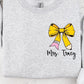Gray sweatshirt with a yellow pencil bow and 'Mrs. Tracy' dtf graphic text on a white background