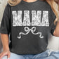 A person wearing a black t-shirt with the text 'MAMA' printed in white, decorated with a white lace-style pattern and a bow at the bottom.
