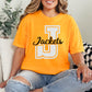 Person wearing an orange 'Jackets' t-shirt sitting on a couch.