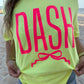 Person wearing a bright yellow t-shirt with 'DASH' printed in pink on a beach.