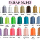 Collection of thread spools in various colors with labels above them.