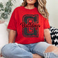 Person wearing a red 'Bulldogs' t-shirt sitting on a couch.